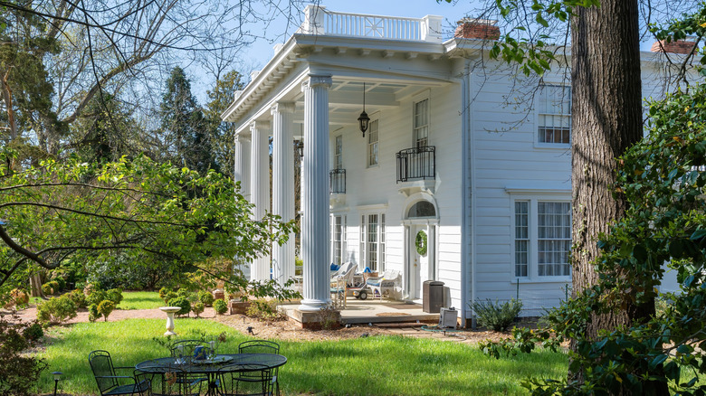 Historic Southern home with large columns and wraparound porch