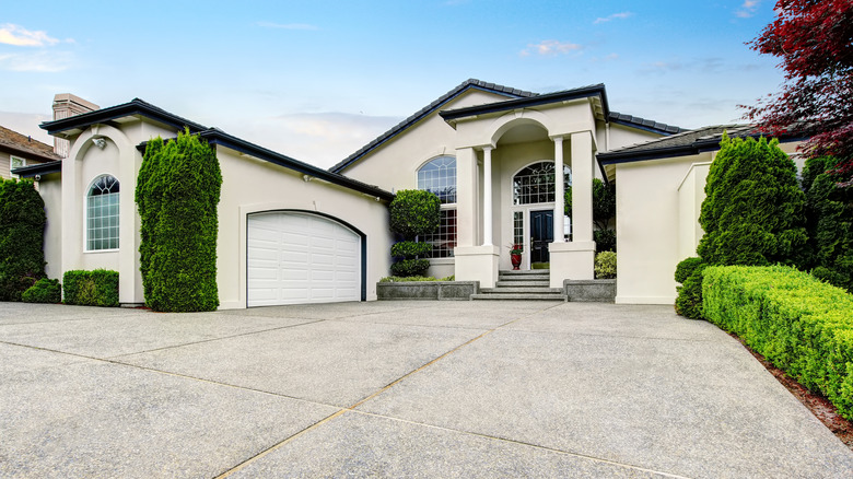 A luxurious home with a large concrete driveway
