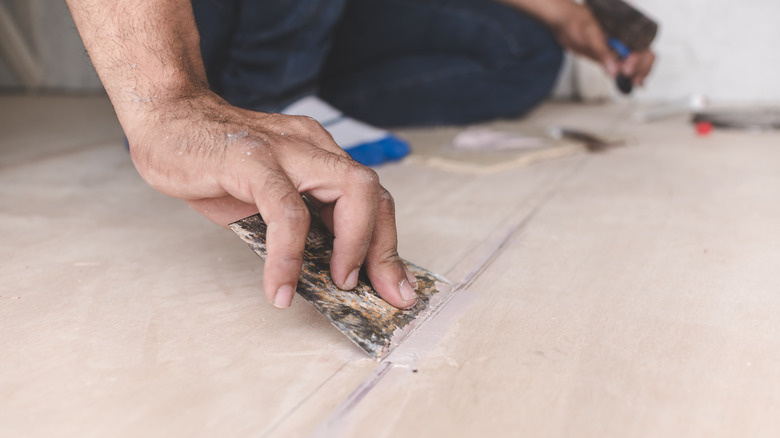 Carpenter using filler on plywood
