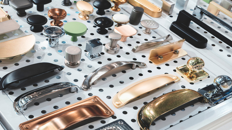 pegboard full of cabinet hardware options such as knobs and pulls