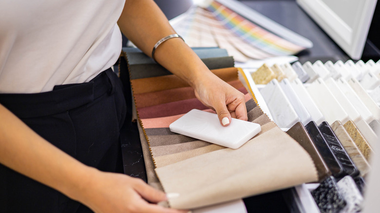 Woman comparing countertop samples and colors