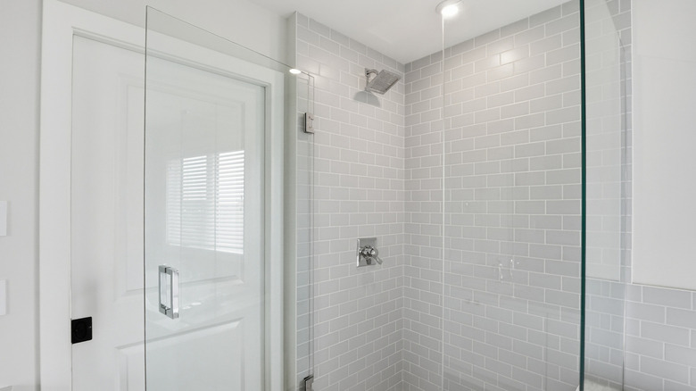 A sleek, glass-doored shower enclosure.
