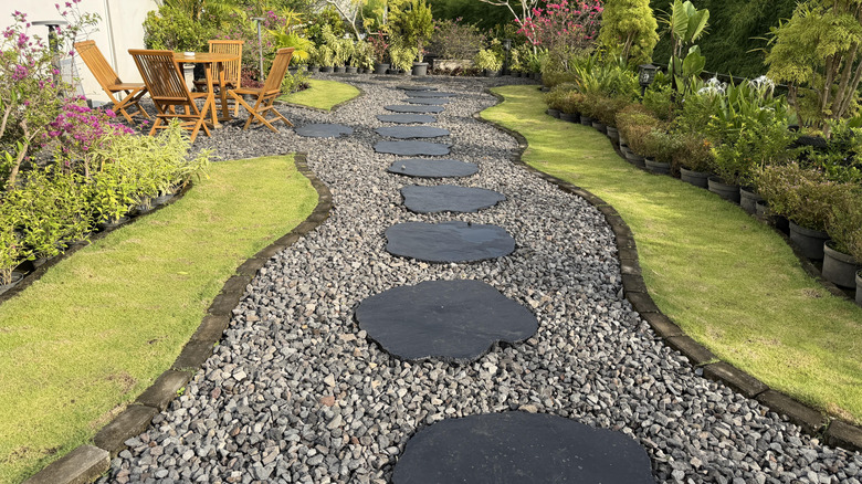 Curved gravel path leading through lush garden