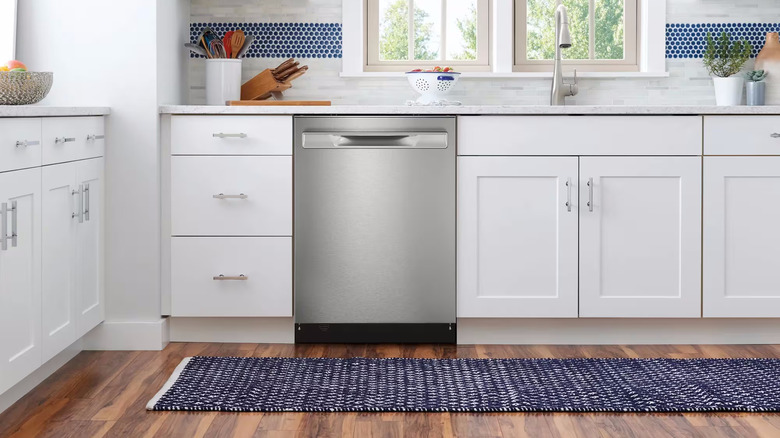 Frigidaire dishwasher with stainless front and recessed handle in kitchen