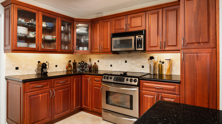Kitchen featuring cherry cabinets and black granite countertops