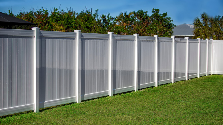 Large white fence bordering yard