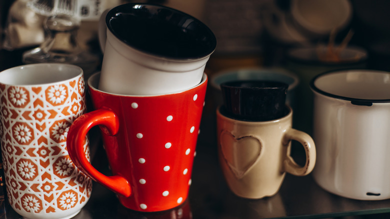 Stack of mismatched coffee cups