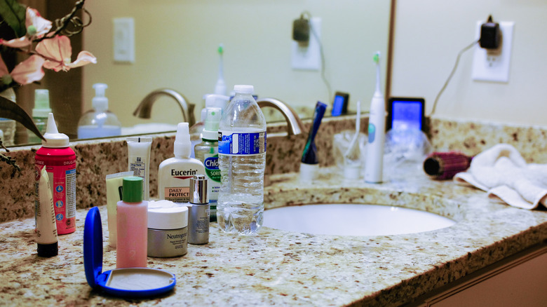 Bathroom countertop with small item clutter