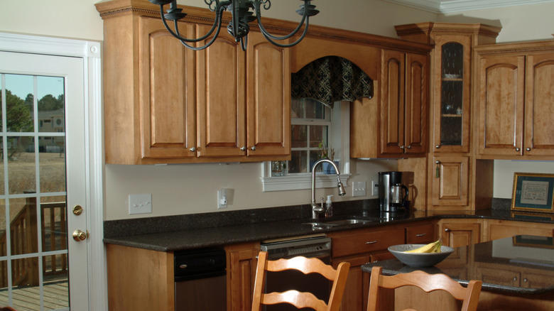 A dated kitchen with light oak cabinets
