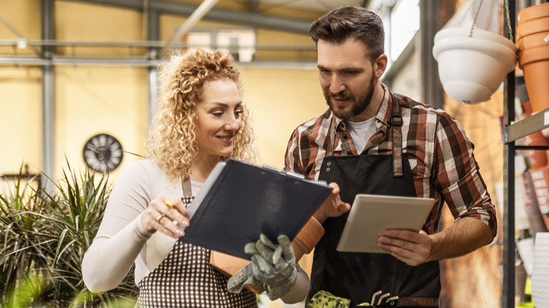 A man and woman look at design ideas in a gardening center