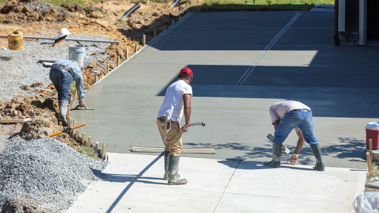 Workers installing a concrete driveway