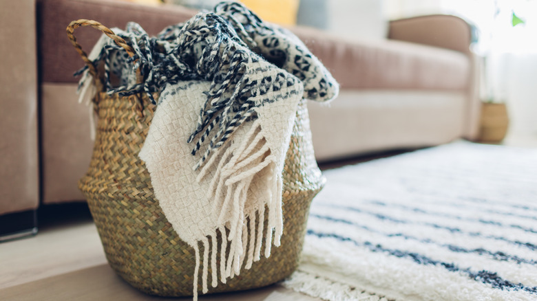 a blanket stuffed in a straw basket