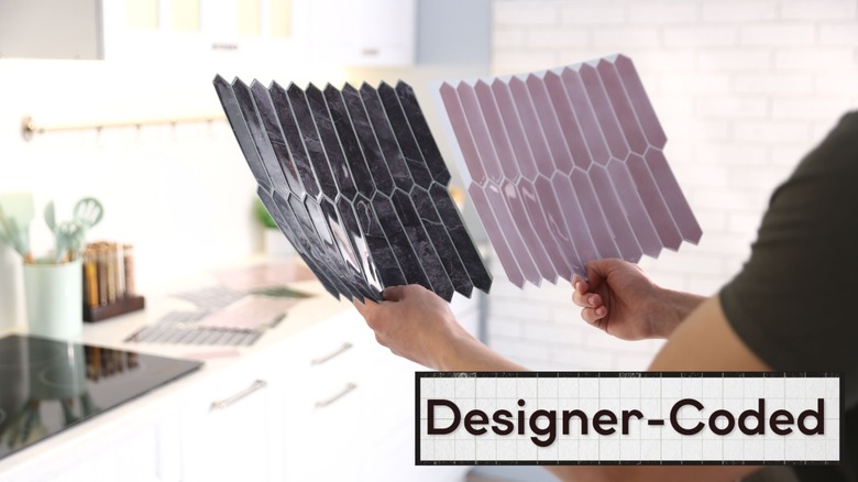 Person comparing two colors of peel-and-stick tile for kitchen backsplash