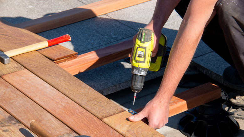 Person installing a new wood deck