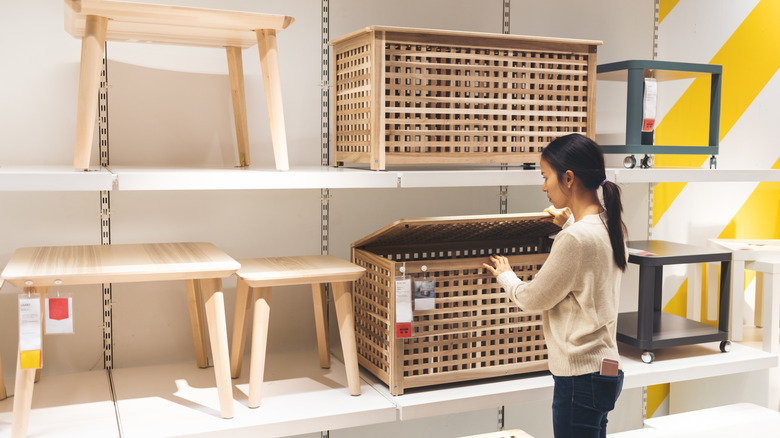 Woman looking at large storage baskets in a store