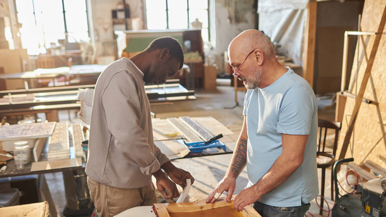 Two men collaborate on building furniture