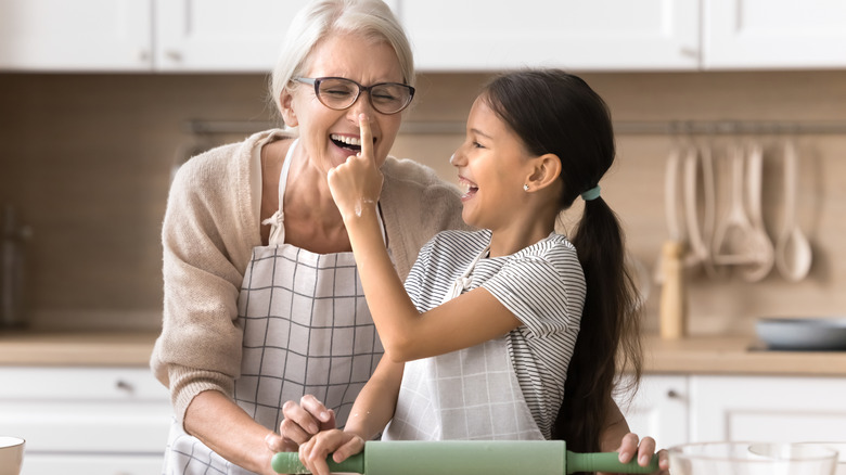 Grandmother and granddaughter baking together