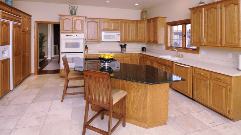 Orange highlights on oak cabinets in kitchen