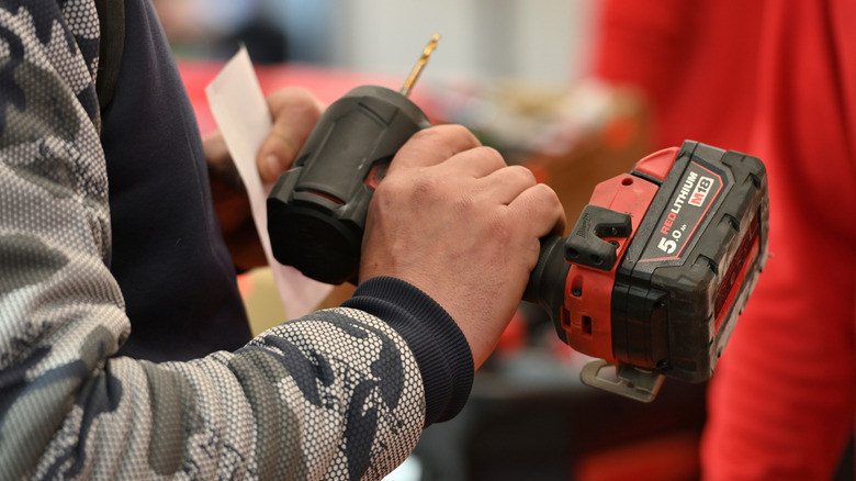 Man looking at a Milwaukee tool in a store