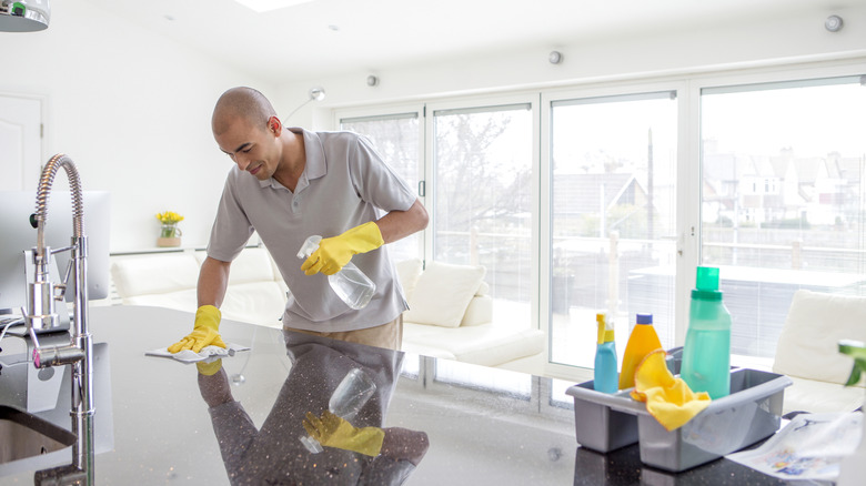 Man cleaning kitchen counters