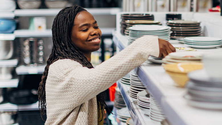 A woman shops for colorful dishes