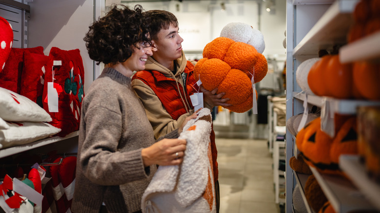 A mother and son are shopping for Halloween decor