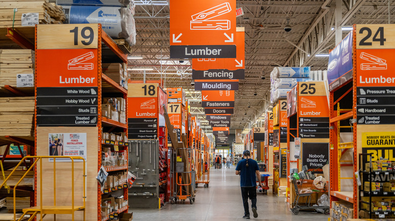 A man walks down the main aisle of Home Depot