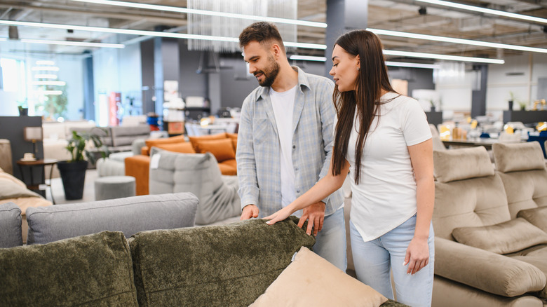 Two people shopping in a sofa showroom