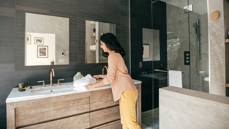Woman organizing a bathroom countertop