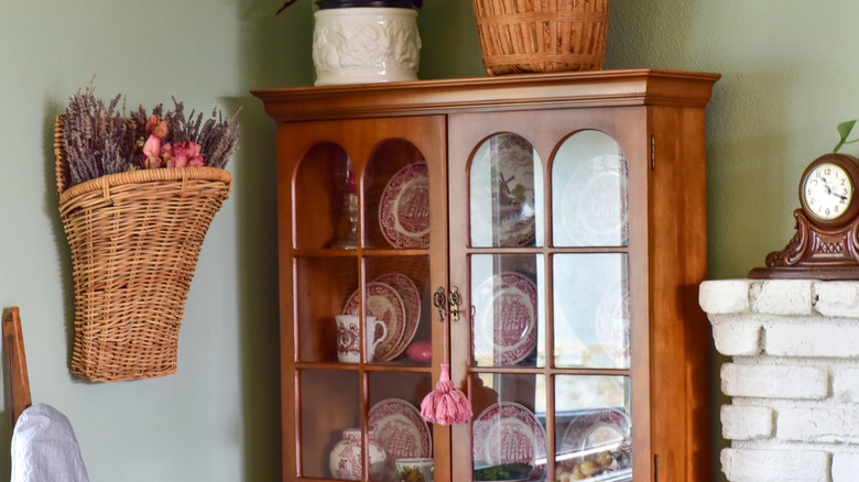 A vintage wooden hutch in a cozy kitchen