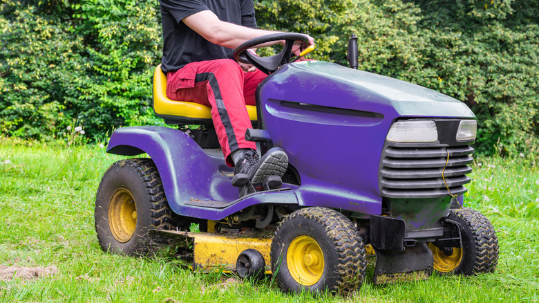 Person on a riding lawn mower