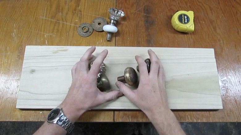 Hands grabbing old door knobs