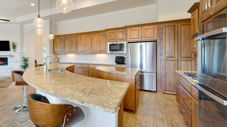 Open kitchen with honey oak cabinets