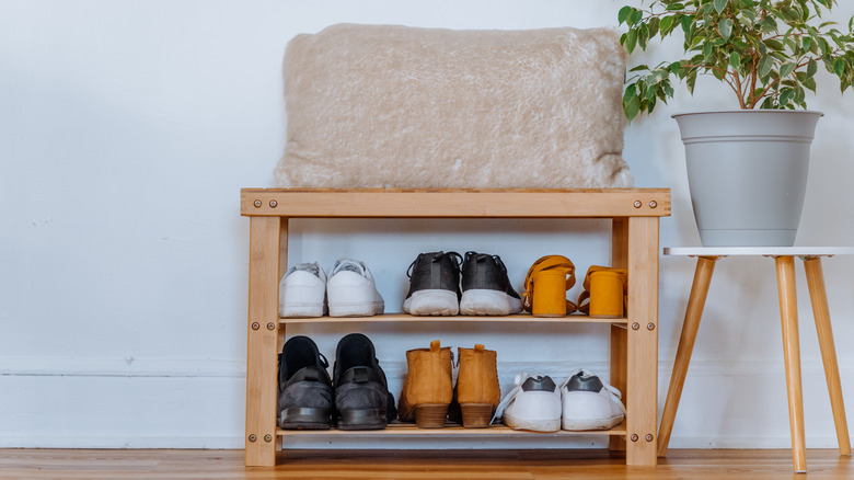 Shoe rack bench in front entryway of a home