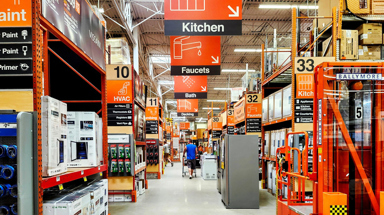 Man with a cart shopping at a Home Depot store