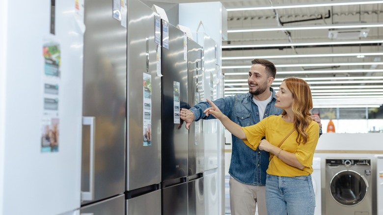 Couple shopping for a refrigerator