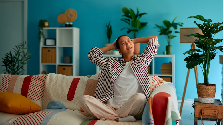 A woman relaxes in a funky living room