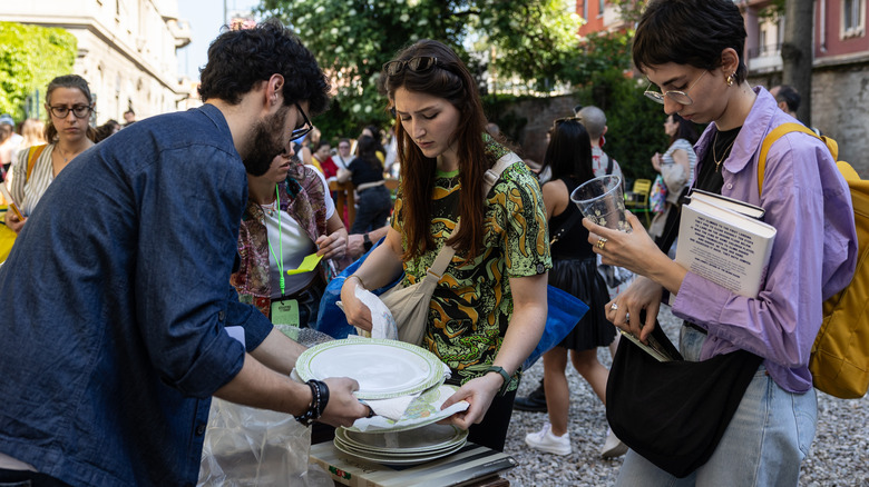 Friends looking through dishes at a flea market