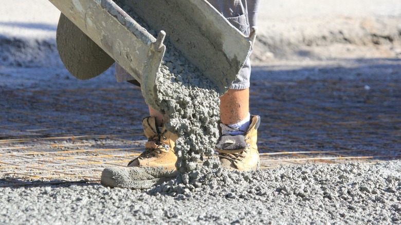 Person pouring concrete for new driveway