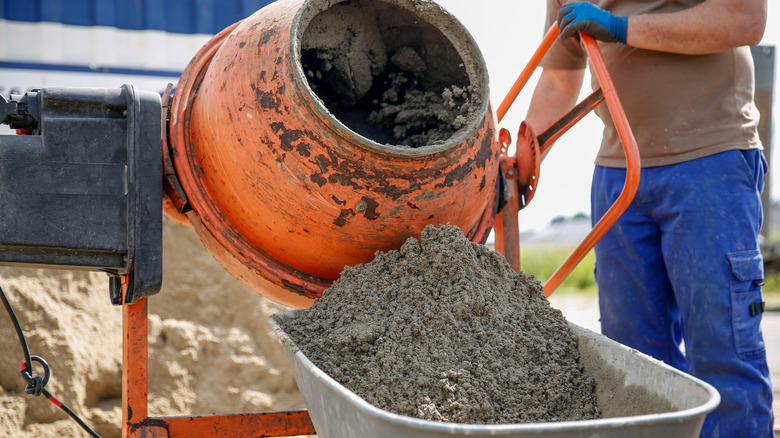 Worker making concrete in a mixer
