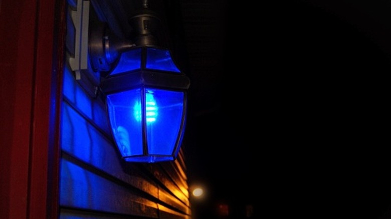 A blue light bulb on a porch