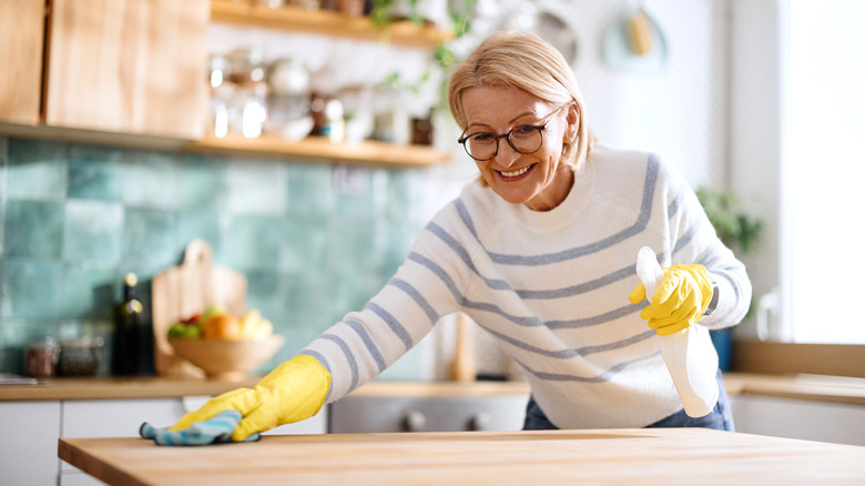Woman wiping down her kitchen counters