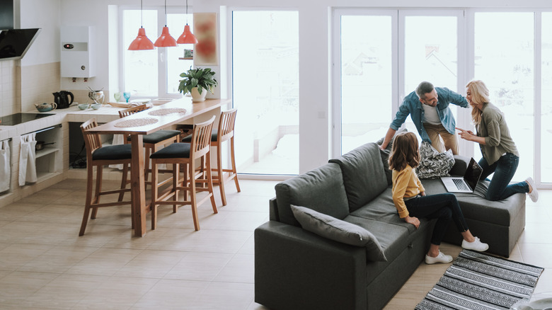 People gathered on the sofa in an open floor plan home.