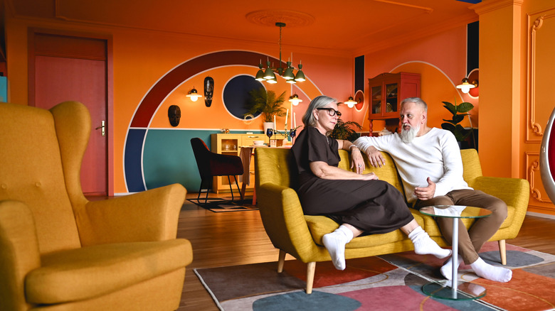 A couple sits in a colorful living room