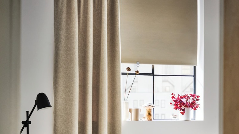 IKEA FÖNSTERBLAD Black-out Roller Blind layered under beige curtain