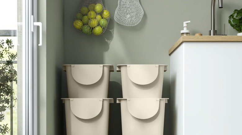Stacked TRÖSKNING Bins with hanging produce storage bags above