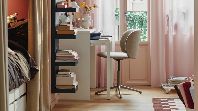 A white LÄNGDHOPP extendable desk in a small home office