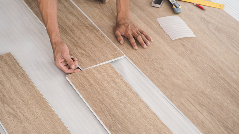 Technician cutting and leveling hardwood flooring