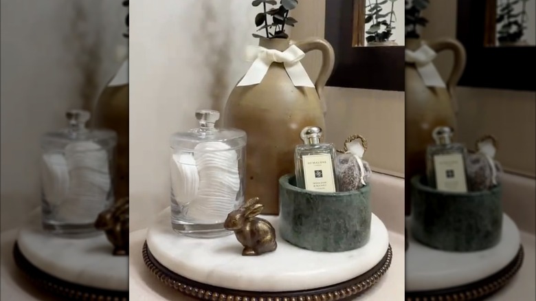 Rotating marble tray with bathroom decor on it