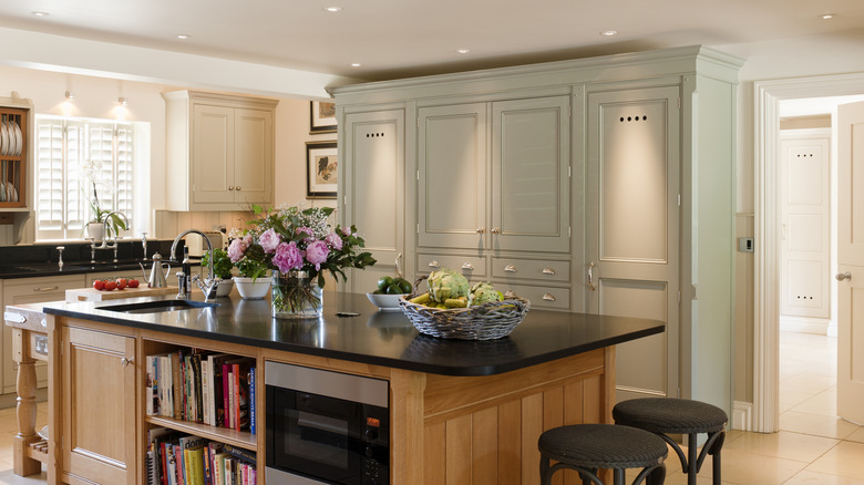 Kitchen with white upper cabinets and honey oak lower cabinets